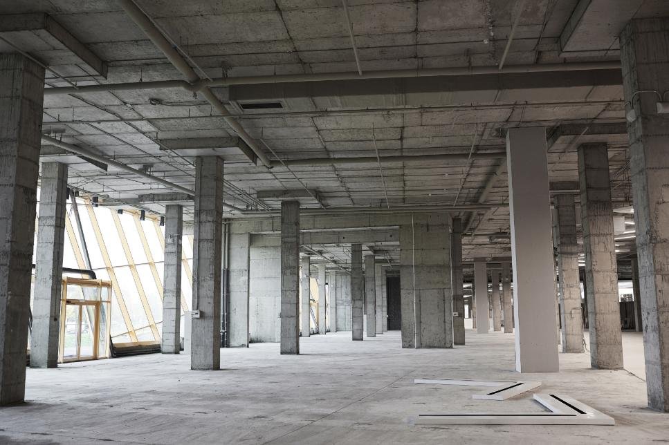 Estructura interior de edificio con pilares y forjados de hormigón armado en fase constructiva.